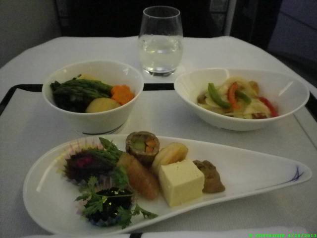 From the top, O-sake from a mountain brewery run by four family members on an island two islands South of the main one. Seaweed the texture of slimy spinach which has spoiled in the fridge (in reality that is not a bad thing). Me thinks it has a lot of iron and is quite pleasant. Pickled veggies with fish in a sort of vinegar sauce. The photo below features the largest dish here close up.